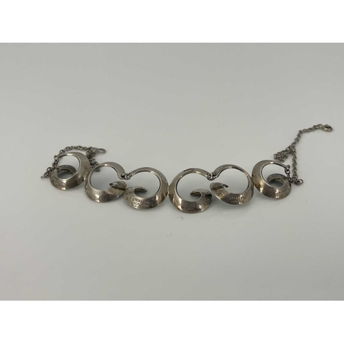 59 - Einar Modal, a Norwegian Modernist silver and enamelled necklace, coiled spiral links in green basse... 