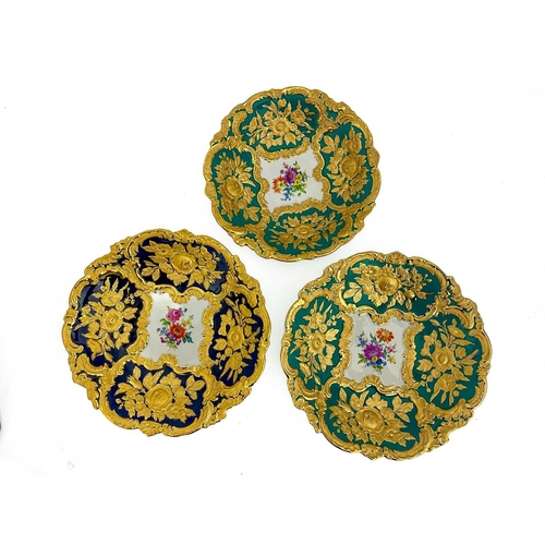 598 - Three 19th century Meissen relief moulded dishes, each with floral cartouches around a central paint... 