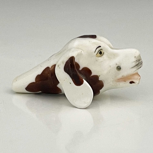 736 - A Staffordshire porcelain novelty dog whistle, 19th century, modelled in the form of a spaniel's hea... 