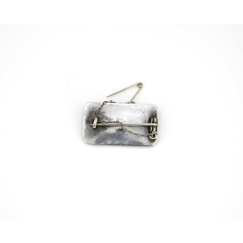 34 - An Arts and Crafts silver and opal cabochon brooch, rectangular form in the Anglo Saxon revival, the... 