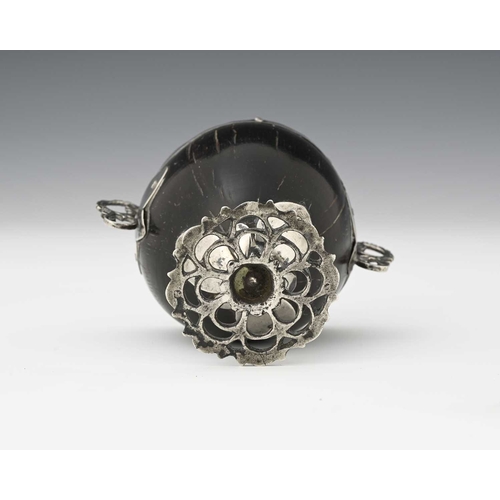 56 - An 18th century Spanish Colonial 'coco chocolatero' white metal mounted chocolate cup, the coconut b... 