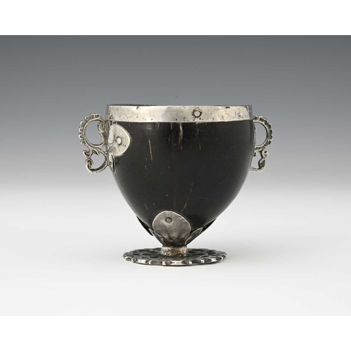 56 - An 18th century Spanish Colonial 'coco chocolatero' white metal mounted chocolate cup, the coconut b... 