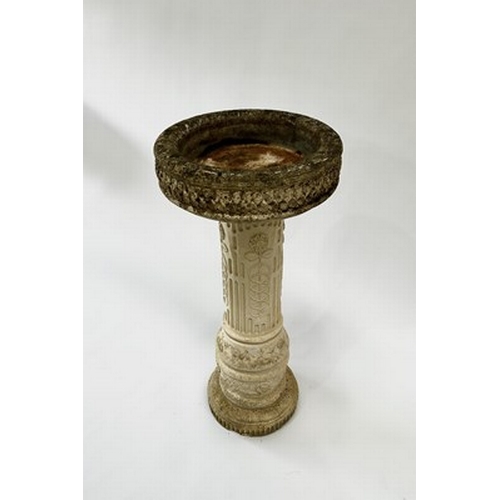 1003 - A sandstone composite birdbath with Roman numerals dial and front figurine, measuring 81.5cm high an... 