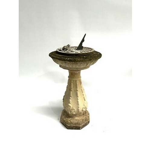 1003 - A sandstone composite birdbath with Roman numerals dial and front figurine, measuring 81.5cm high an... 