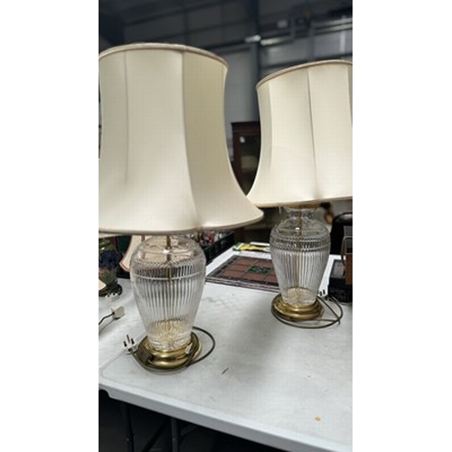 119 - A pair of moulded crystal table lamps with brass base and necking, in a baluster form, 50cm high (2)