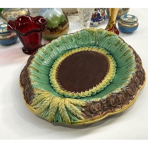 132 - A mid-19th century majolica ceramic oval-shaped bread plate moulded with radiating ears of corn belo... 