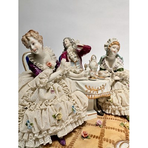 147 - A large Unter Weiss Bach porcelain figure group of two ladies and a gentleman in 18th-century dress,... 