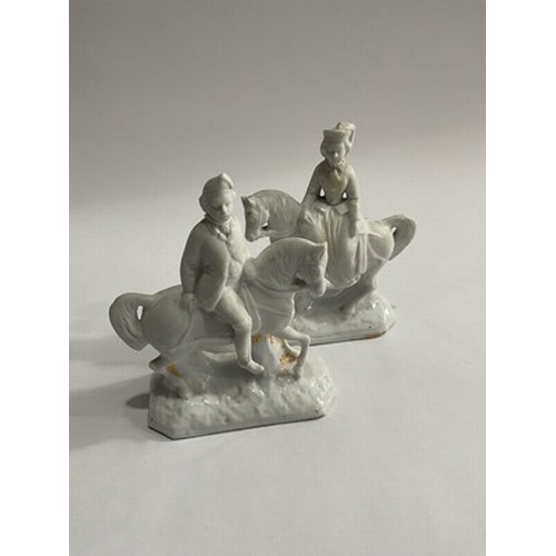 151 - A pair of white Dresden porcelain figurines modelled as a man and woman on horseback (2)