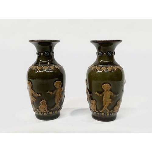 156 - A pair of miniature Royal Doulton 19th century vases, with the freize in relief depicting a boy and ... 