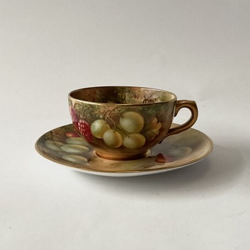 178 - Townsend for Royal Worcester, a fruit painted cup and saucer, decorated in full with cherries, grape... 