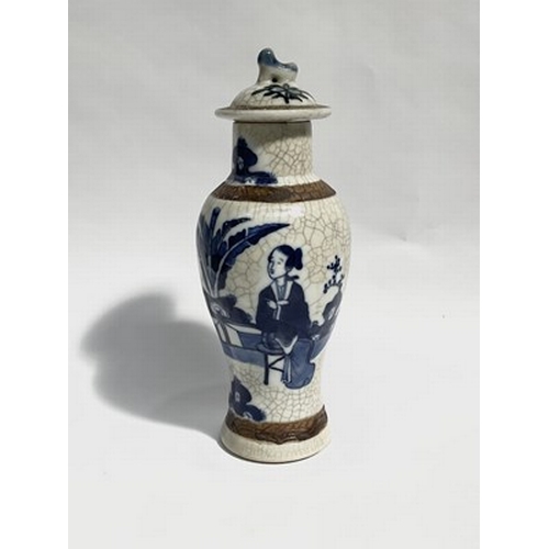 211 - A Chinese 19th-century baluster vase with lid, and crackle glaze, featuring domestic narrative relie... 