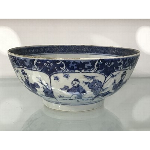 213 - A Chinese blue and white bowl, footed form, painted with panels of boys within a foliate border, 24c... 