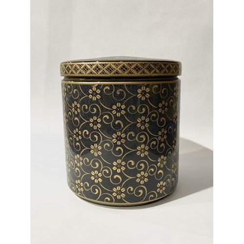 225 - A Chinese cylindrical porcelain jar and lid, with decorative gilt floral medallions on a black with ... 