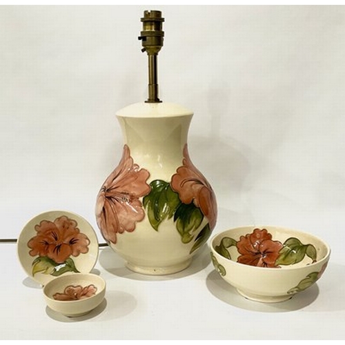 228 - A Moorcroft Hibiscus patterned baluster lamp, set on a consistent cream ground, together with a bowl... 