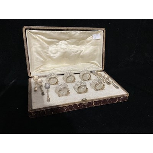 264 - A cased set of six French silver gilt mounted and cut glass salt cellars with cast shell spoons in t... 