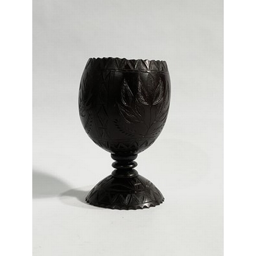 280 - A carved Act of Union type coconut cup, probably 18th century, with a turned stem and carved base, t... 