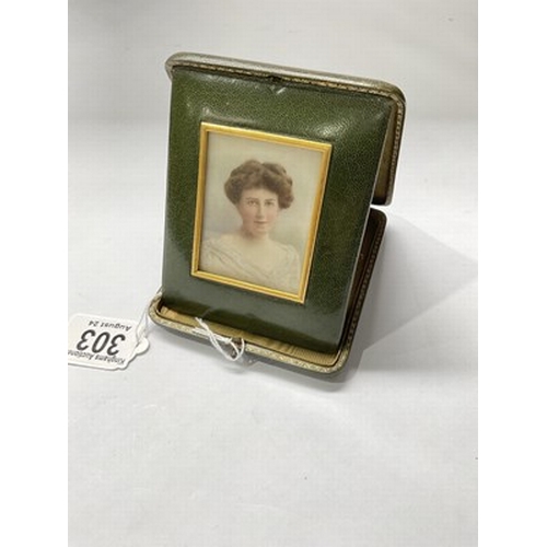 303 - A portrait miniature, circa. 1900, painted to depict an Edwardian lady, within a green silk and gilt... 