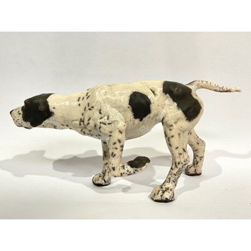 517 - Kenza Rudge (British, b.1966), Studio Pottery: a Raku-fired pointer gun dog, front left leg raised, ... 