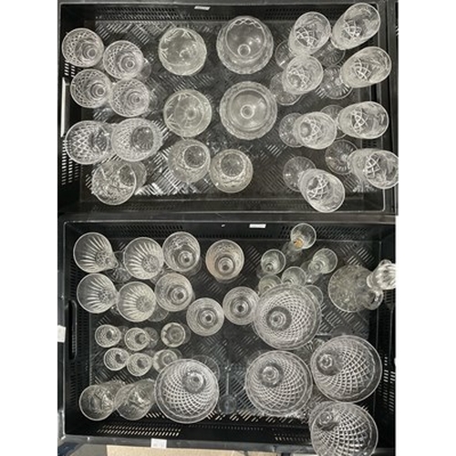 55 - An assortment of cut and moulded glasses to include Waterford and Tudor (2 trays)