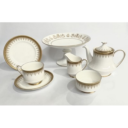 75 - A small Paragon Athena tea set with gold lacing set on a white fluted porcelain background, gloss gl... 