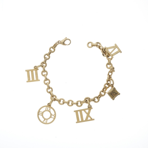 108 - Tiffany & Co., an 18ct gold Atlas charm bracelet, maker's marks for Tiffany & Co., hallmarks for Lon... 