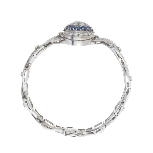 125 - A mid 20th century platinum circular-cut diamond bracelet, with transitional-cut diamond and sapphir... 