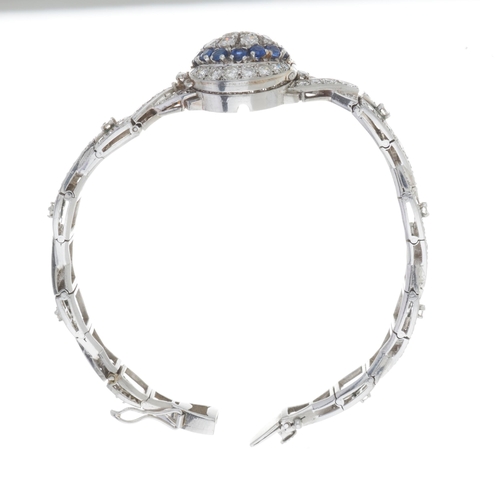 125 - A mid 20th century platinum circular-cut diamond bracelet, with transitional-cut diamond and sapphir... 