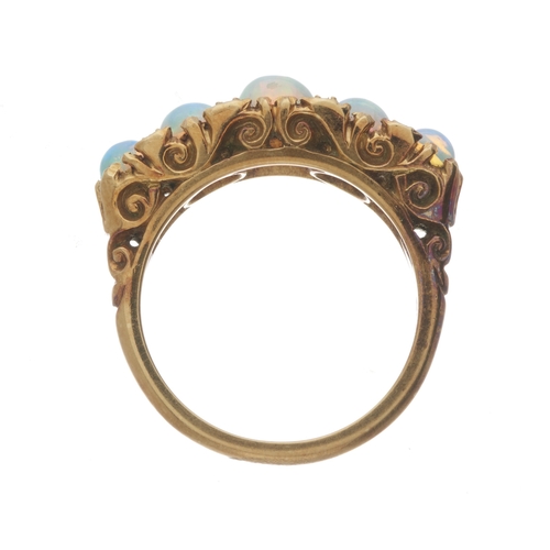 130 - A mid 20th century 18ct gold graduated opal cabochon dress ring, with single-cut diamond double spac... 