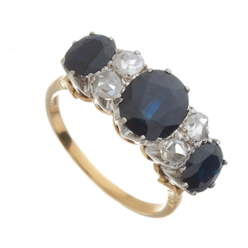 132 - A mid 20th century 18ct gold sapphire three-stone ring, with rose-cut diamond double spacers, princi... 