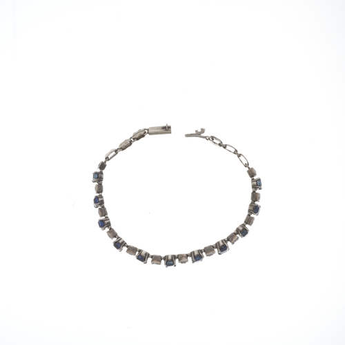 133 - A mid 20th century silver graduated cushion-shape sapphire line bracelet, with circular-shape white ... 