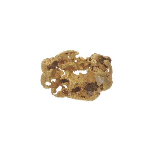 136 - A gold nugget, measuring approximately 8.8mm by 3.2mm, 5.7g