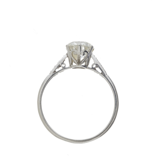 141 - An Art Deco platinum transitional-cut diamond single-stone ring, with diamond shoulders, principal d... 