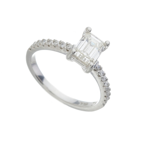 160 - A platinum rectangular-shape diamond single-stone ring, with brilliant-cut diamond line shoulders, p... 