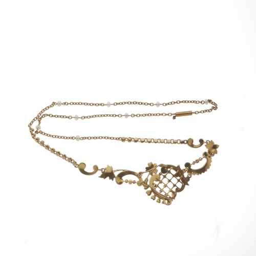 18 - An Edwardian 15ct gold split pearl openwork necklace, suspended from a seed pearl accent trace-link ... 