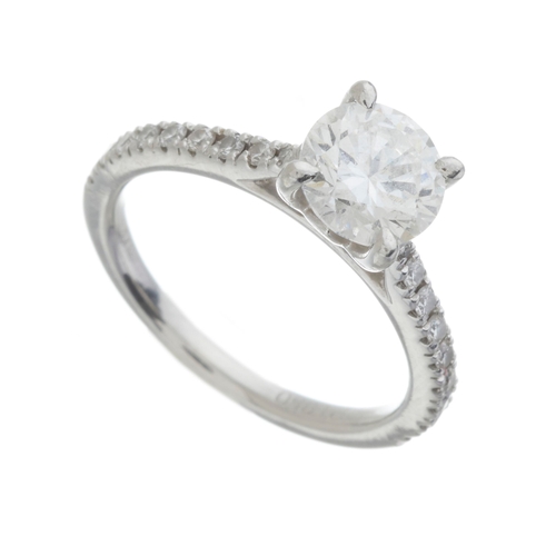 182 - A platinum brilliant-cut diamond single-stone ring, with similarly-cut diamond line shoulders, princ... 