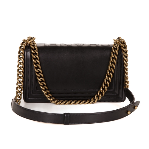 251 - Chanel, a black Medium Boy handbag, designed with a smooth calf leather exterior and ribbed border, ... 