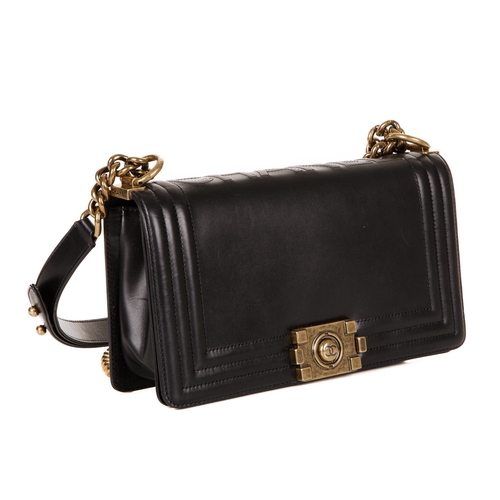 251 - Chanel, a black Medium Boy handbag, designed with a smooth calf leather exterior and ribbed border, ... 