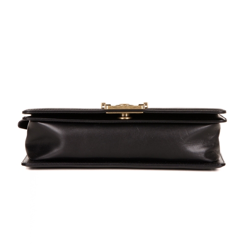 251 - Chanel, a black Medium Boy handbag, designed with a smooth calf leather exterior and ribbed border, ... 