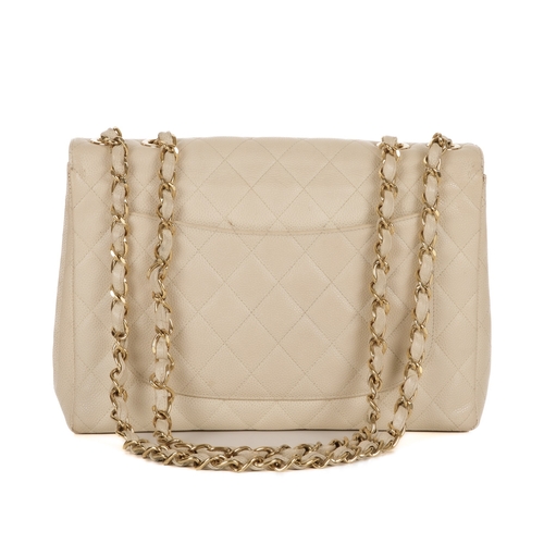 253 - Chanel, a Jumbo Single Flap handbag, featuring the maker's signature diamond quilted cream caviar le... 