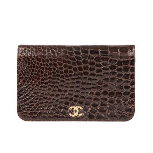 256 - Chanel, a vintage crocodile handbag, crafted from glossy brown crocodile skin, featuring a gold-tone... 