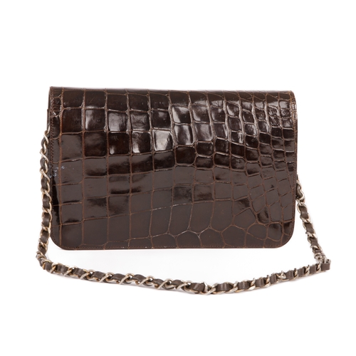 256 - Chanel, a vintage crocodile handbag, crafted from glossy brown crocodile skin, featuring a gold-tone... 