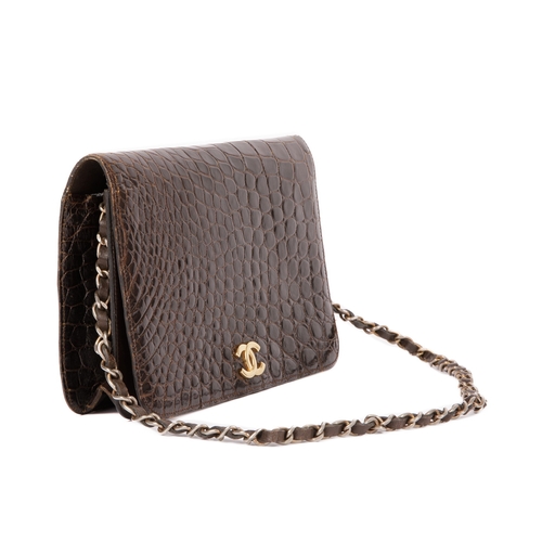 256 - Chanel, a vintage crocodile handbag, crafted from glossy brown crocodile skin, featuring a gold-tone... 