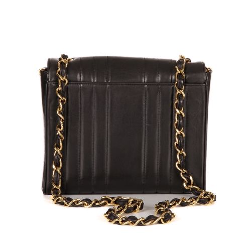 259 - Chanel, a vintage vertical Classic Flap handbag, crafted from black lambskin leather, with vertical ... 