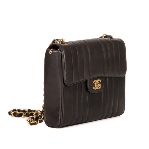 259 - Chanel, a vintage vertical Classic Flap handbag, crafted from black lambskin leather, with vertical ... 