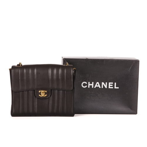 259 - Chanel, a vintage vertical Classic Flap handbag, crafted from black lambskin leather, with vertical ... 