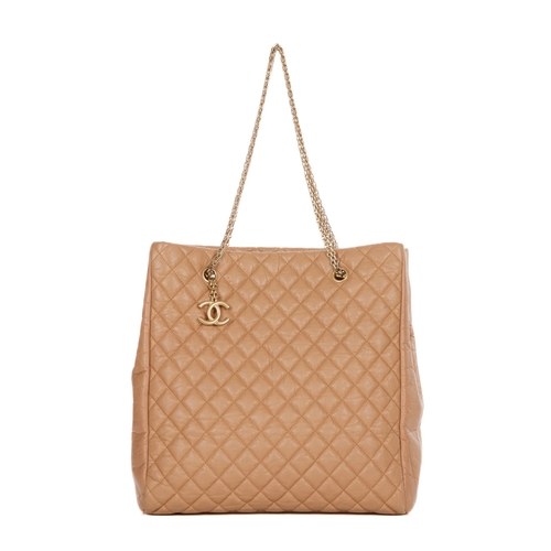 262 - Chanel, a large tan leather tote, crafted from diamond quilted crinkled calfskin leather, with brush... 