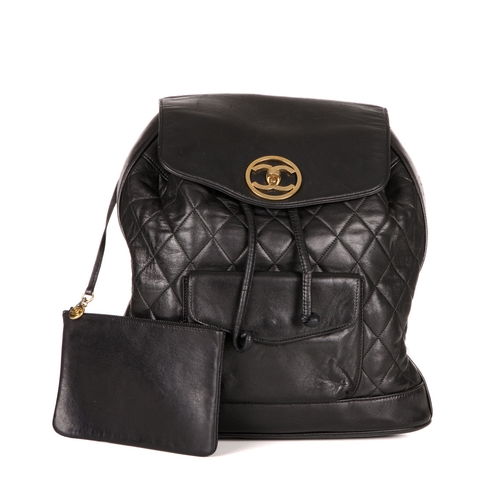 264 - Chanel, a vintage black quilted leather backpack w/pouch, featuring gold-tone hardware, a front patc... 