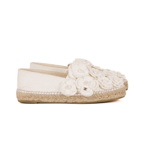 268 - Chanel, a pair of Camellia espadrilles, designed with cream canvas uppers with layered camellia flow... 