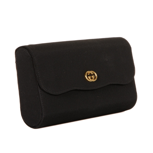 305 - Gucci, a vintage clutch, designed with a structured shape, with a black fabric exterior, gold-tone G... 