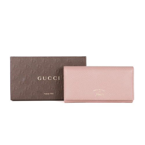 307 - Gucci, a Swing continental wallet, crafted from grained pink leather, featuring the maker's script l... 